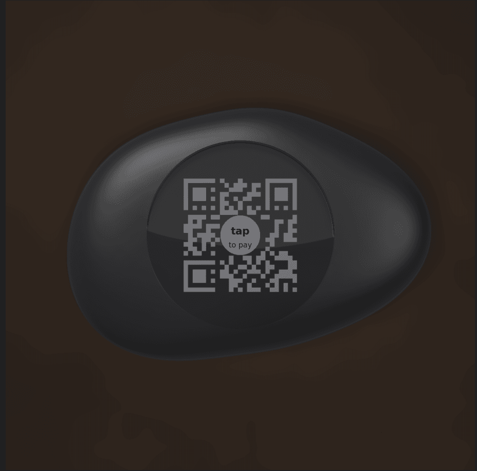 A pebble device on a restaurant table, marked tap to pay